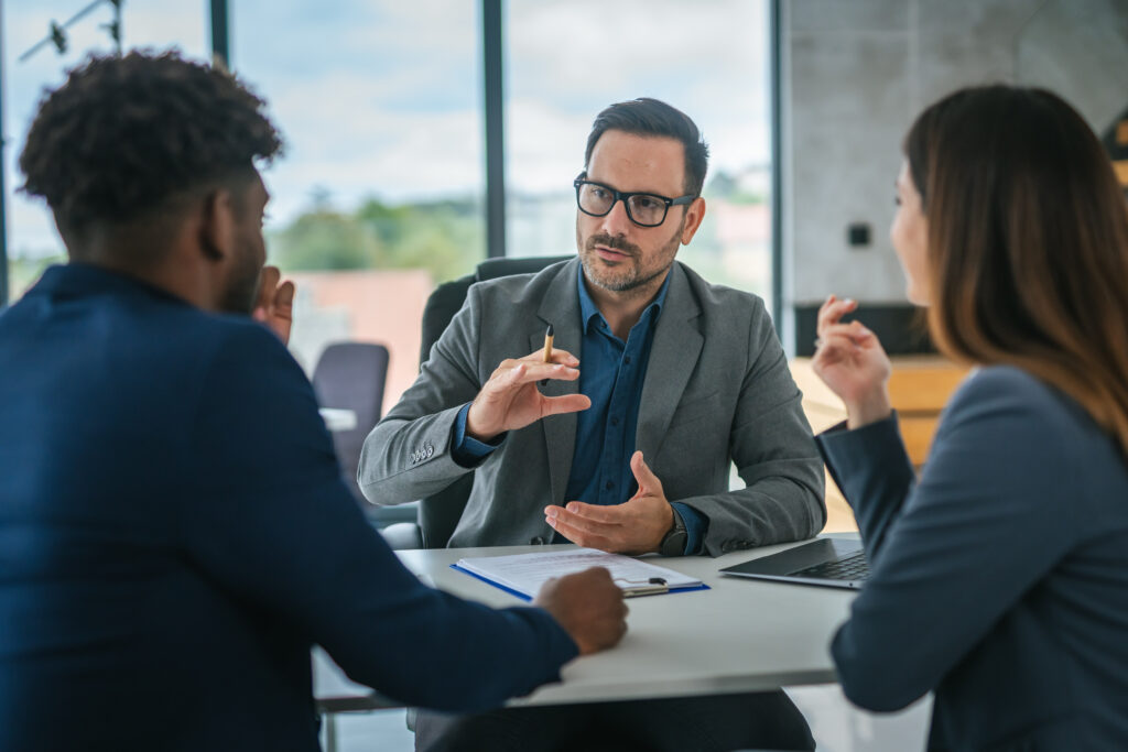 Two insurance executives reviewing claims and underwriting automation results