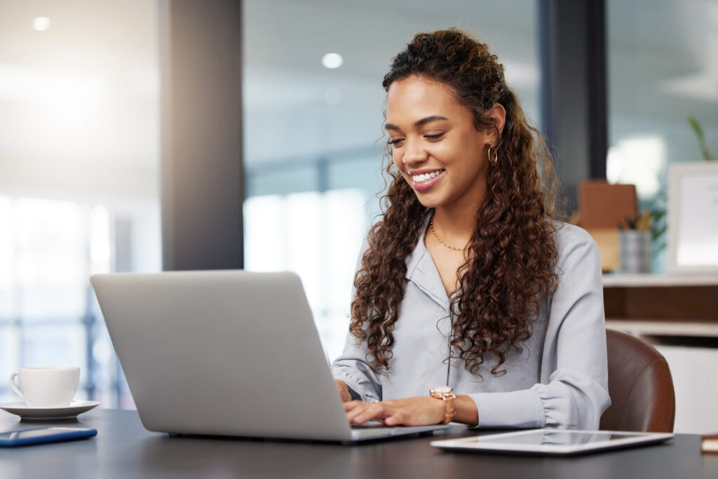 A woman QA engineer working on a laptop